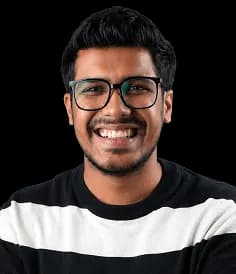 Portrait of a Red Baton team member smiling in glasses and a striped shirt