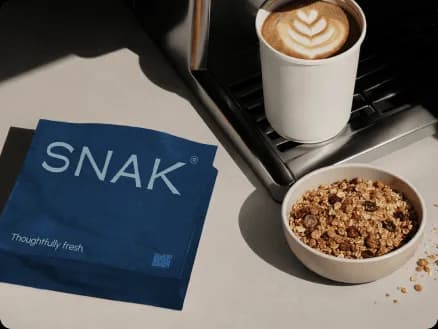 SNAK brand identity design featuring granola packaging coffee and breakfast styling