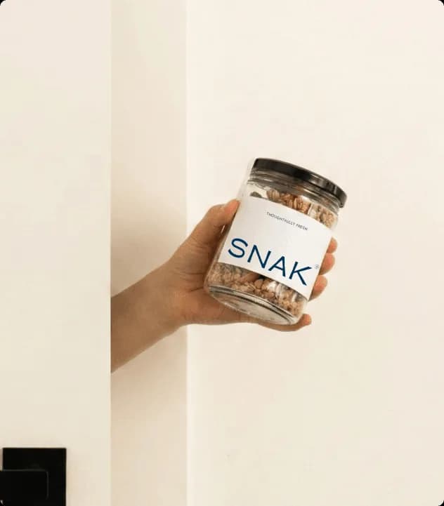 SNAK granola packaging featured in a clean contemporary food and wellness visual