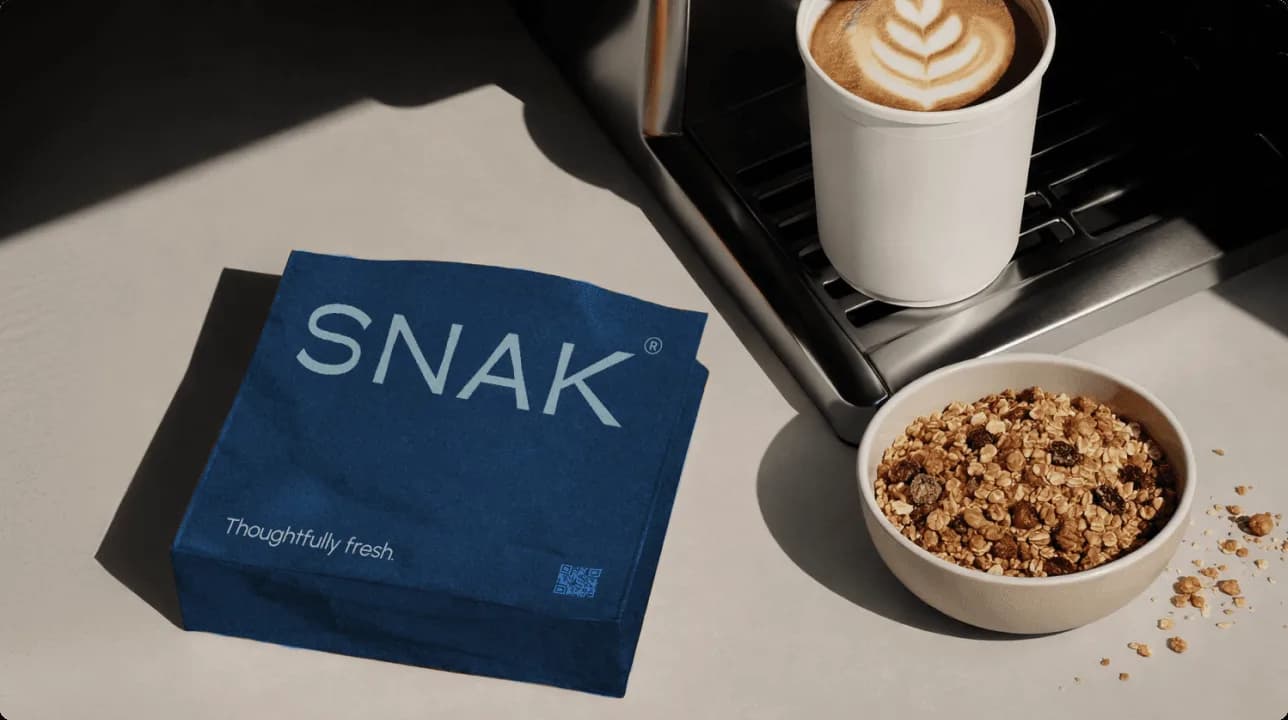 SNAK breakfast brand campaign combining granola packaging with natural food styling