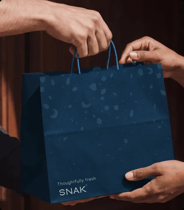 SNAK lifestyle campaign showing granola as part of a balanced premium breakfast routine