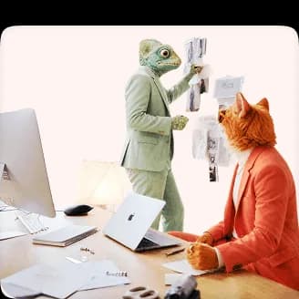 Chameleon presenting ideas on a wall while a cat creative professional takes notes